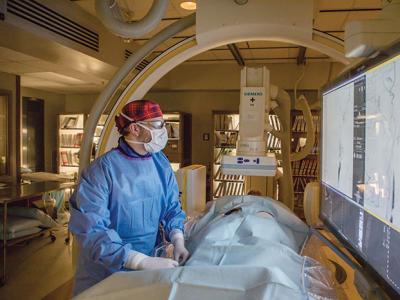 UK neurosurgeon Dr. Justin Fraser, shown here demonstrating a medical procedure, teamed with Dr. Gregory Bix, director of the UK Center for Advanced Translational Stroke Science, to research new treatments to protect brain tissue after a stroke.