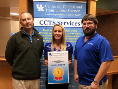 Ickes, center, was selected as winner of the CCTS Science Communication Comic Book Challenge. She is joined by Joel Thompson, PhD, research development director, and Bryan Sanders, marketing assistant and illustrator. 