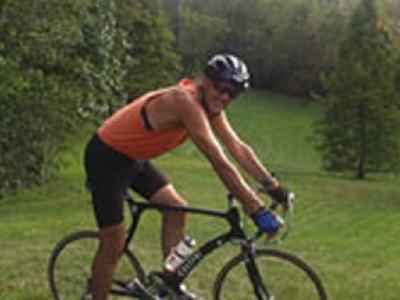 Tom Curry on a bike in a field