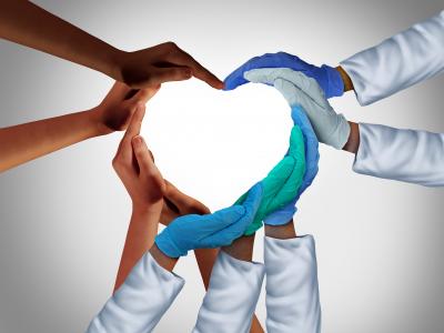 Heart shape made by hands of many skin tones and hands with different medical gloves and wearing white medical coats 