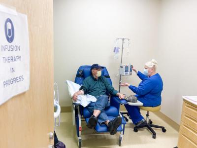 A clinical trial participant receives an infusion. 