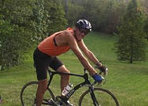 Tom Curry on a bike in a field