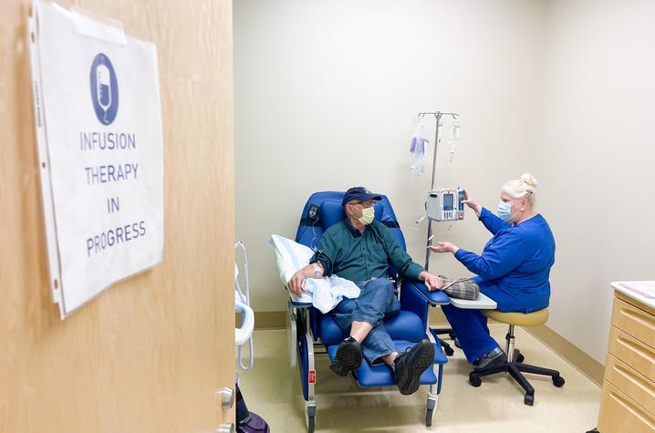 A clinical trial participant receives an infusion. 