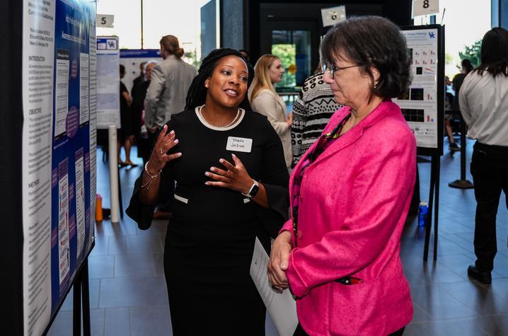 Yolanda Jackson, College of Communication and Information Ph.D. student and TL1 Scholar, shares her Alzheimer’s screening research with NIH Director Monica Bertagnolli. Jeremy Blackburn, Research Communications