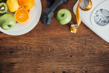 Fruit, dumbbell, and scale