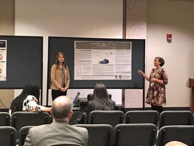 Ashley Gibson and Kacie Bledsoe present their poster.  