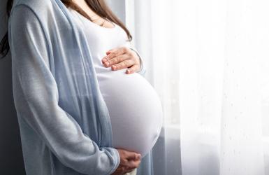 Pregnant woman cradling belly