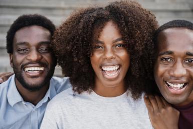 three people smiling