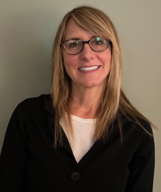 Headshot of Anna Rockich, a white woman in her late 30s, she has straight, blonde hair and wears glasses