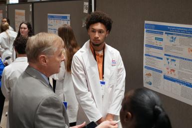 CCTS Co-Director Philip Kern talks with students from Frederick Douglass High School about their research poster.