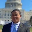 Headshot of Jerron Thomas, a 2021 SPARKler. He's in a suit and tie, standing in front of the Capitol. 