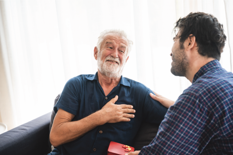 Two men talking and supporting each other.