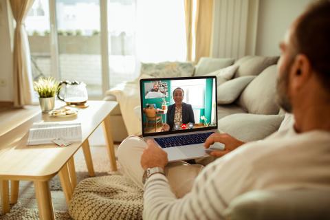 Man on a computer talking to a women on zoom.