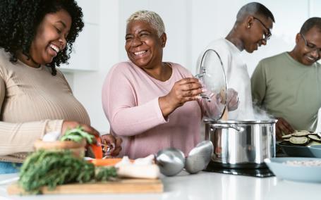 A group of black African American adults cooking. 
