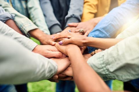 Group of hands in the center. 